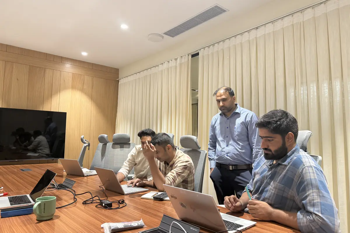 Interns and mentor around the table reviewing a result together